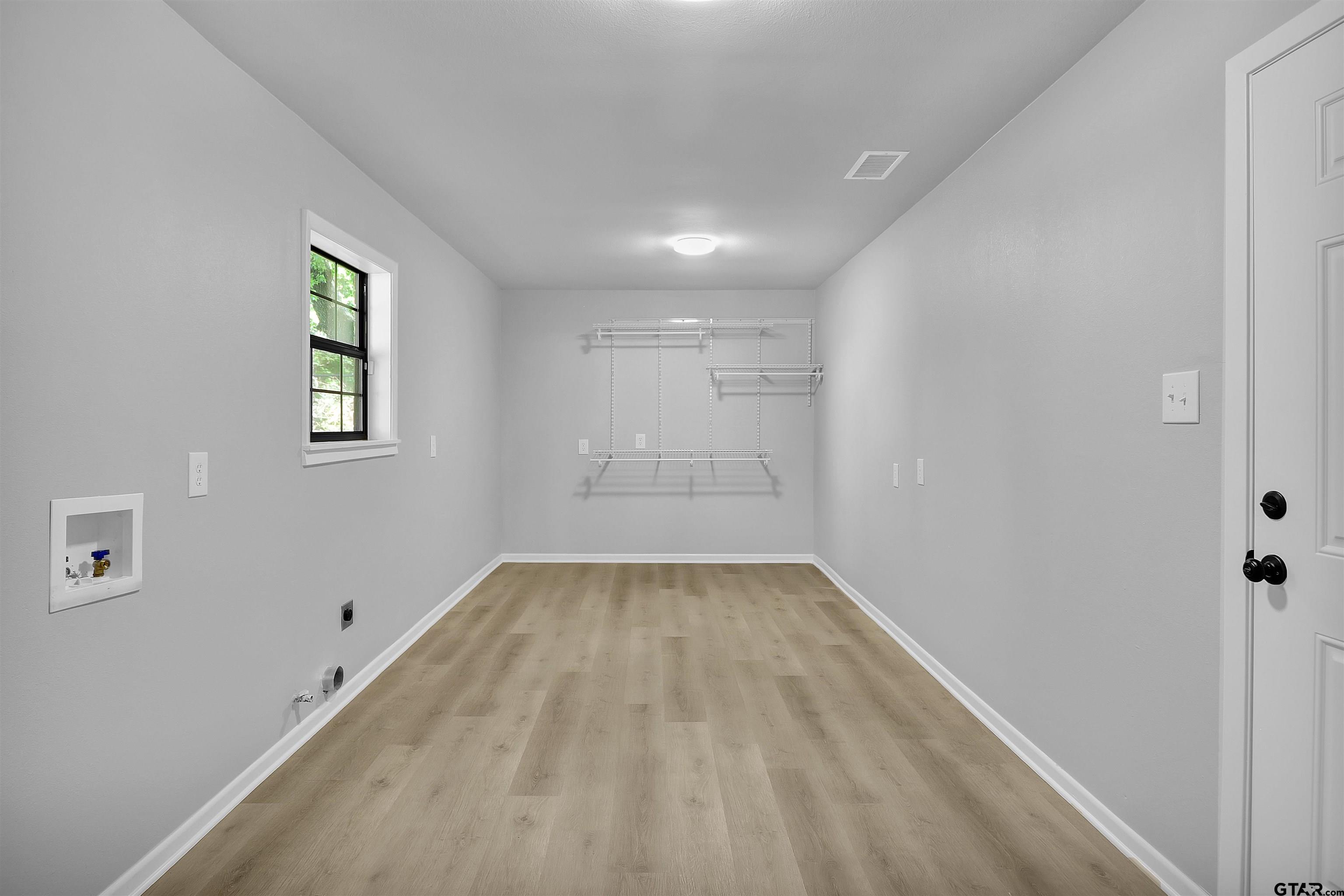 1310 Ridgeview Drive Tyler, TX 75701 - Photo 25 of 30 wooden floor in an empty room with a window
