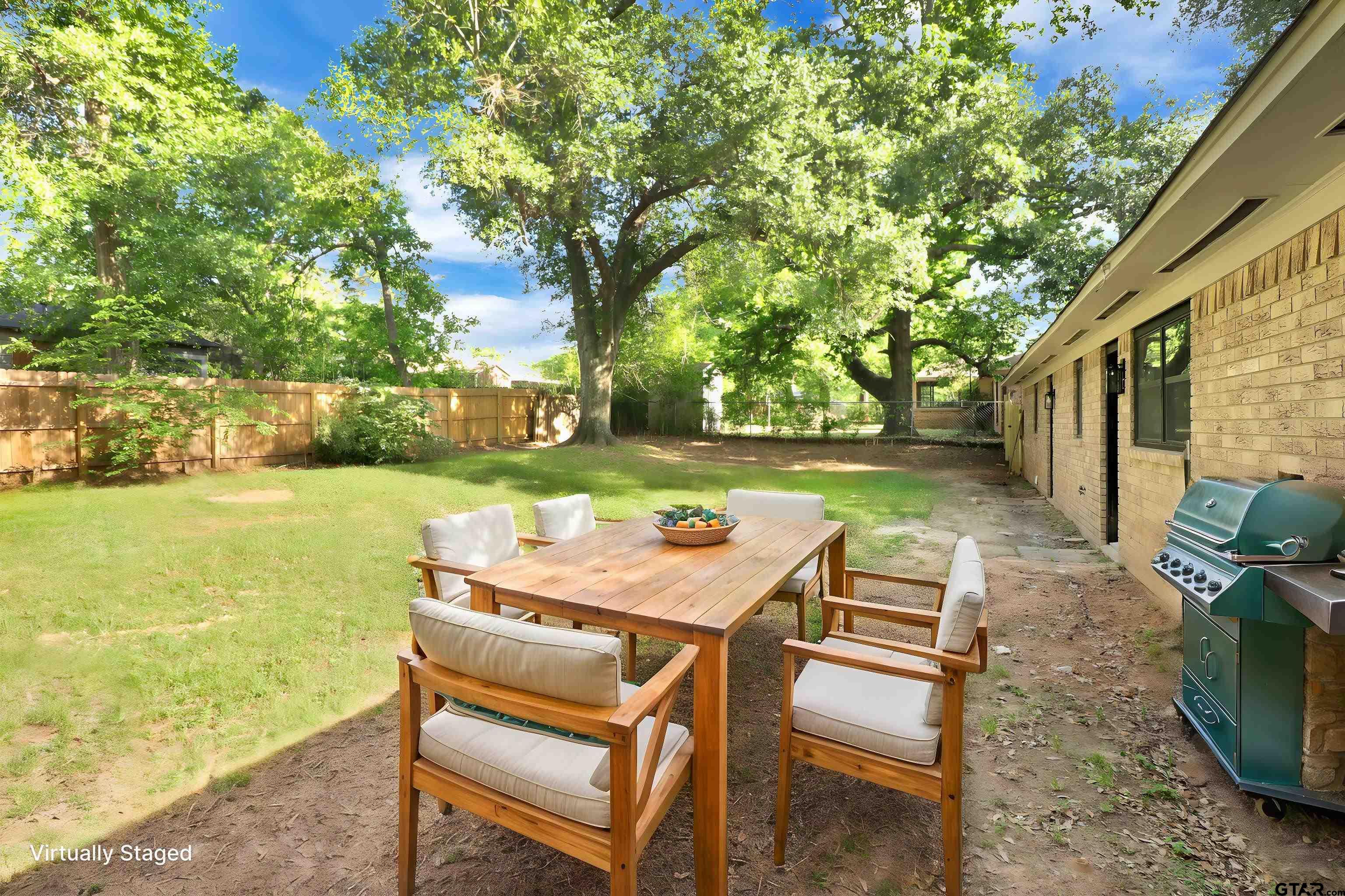 1310 Ridgeview Drive Tyler, TX 75701 - Photo 26 of 30 a view of a patio with table and chairs and potted plants