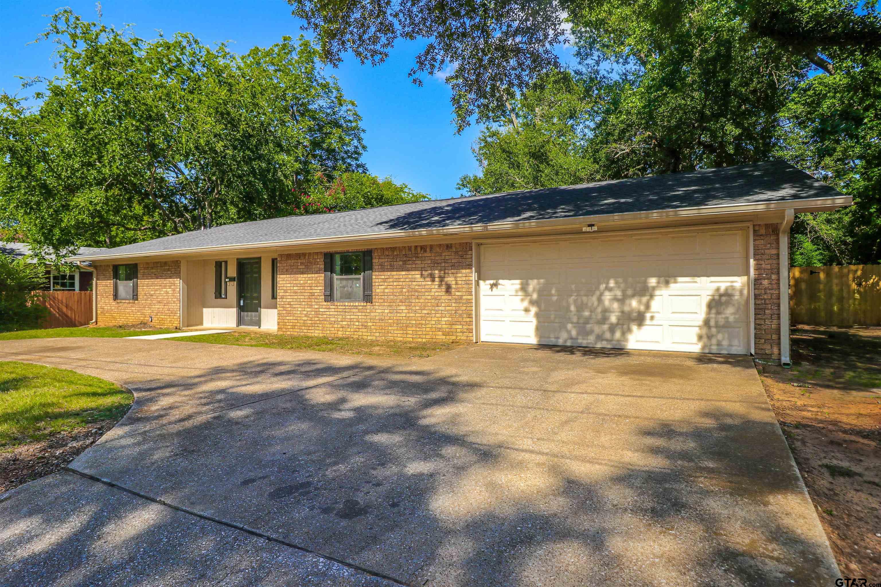 1310 Ridgeview Drive Tyler, TX 75701 - Photo 3 of 30 a front view of a house with a yard and garage