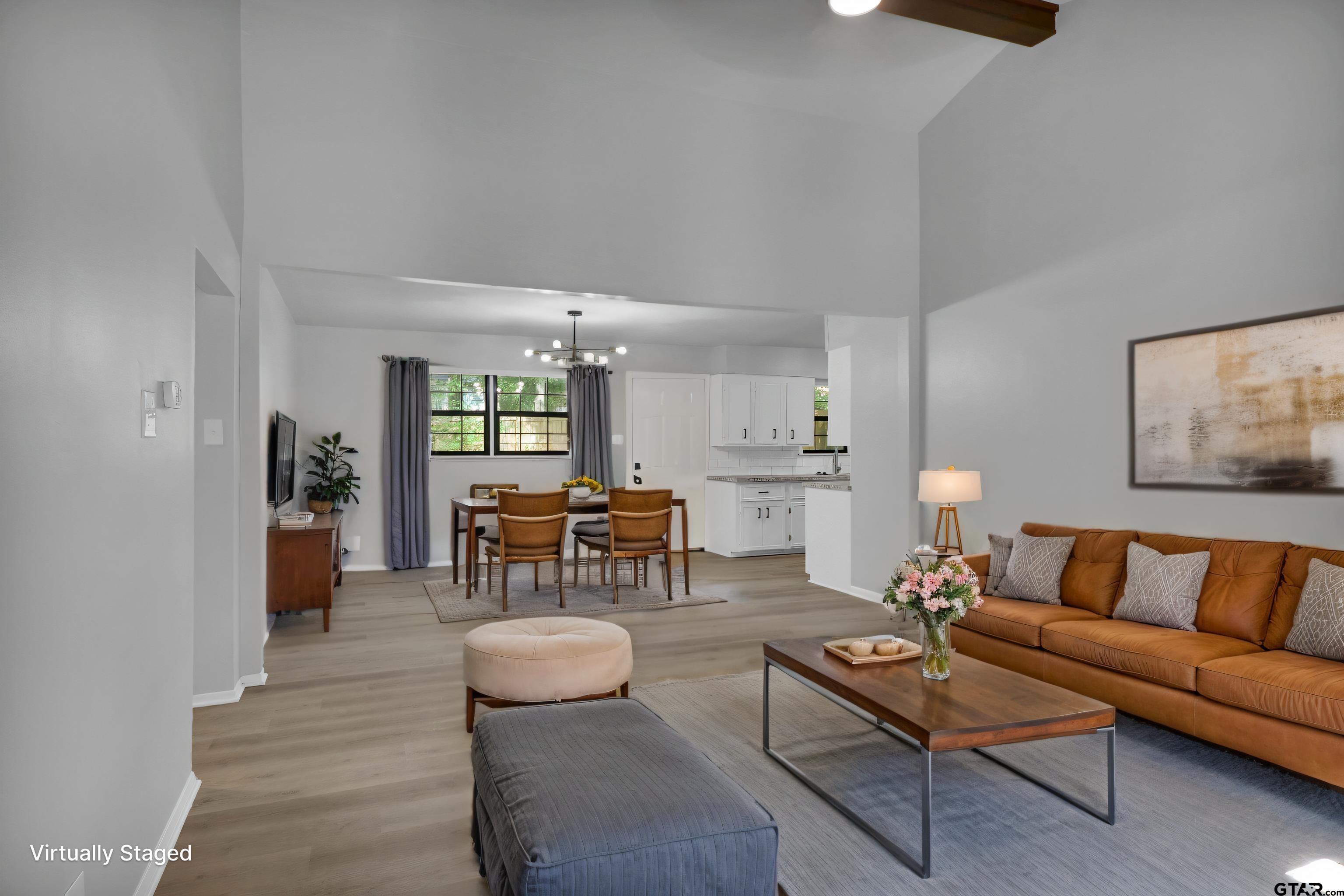1310 Ridgeview Drive Tyler, TX 75701 - Photo 4 of 30 a living room with furniture and a dining table with kitchen view