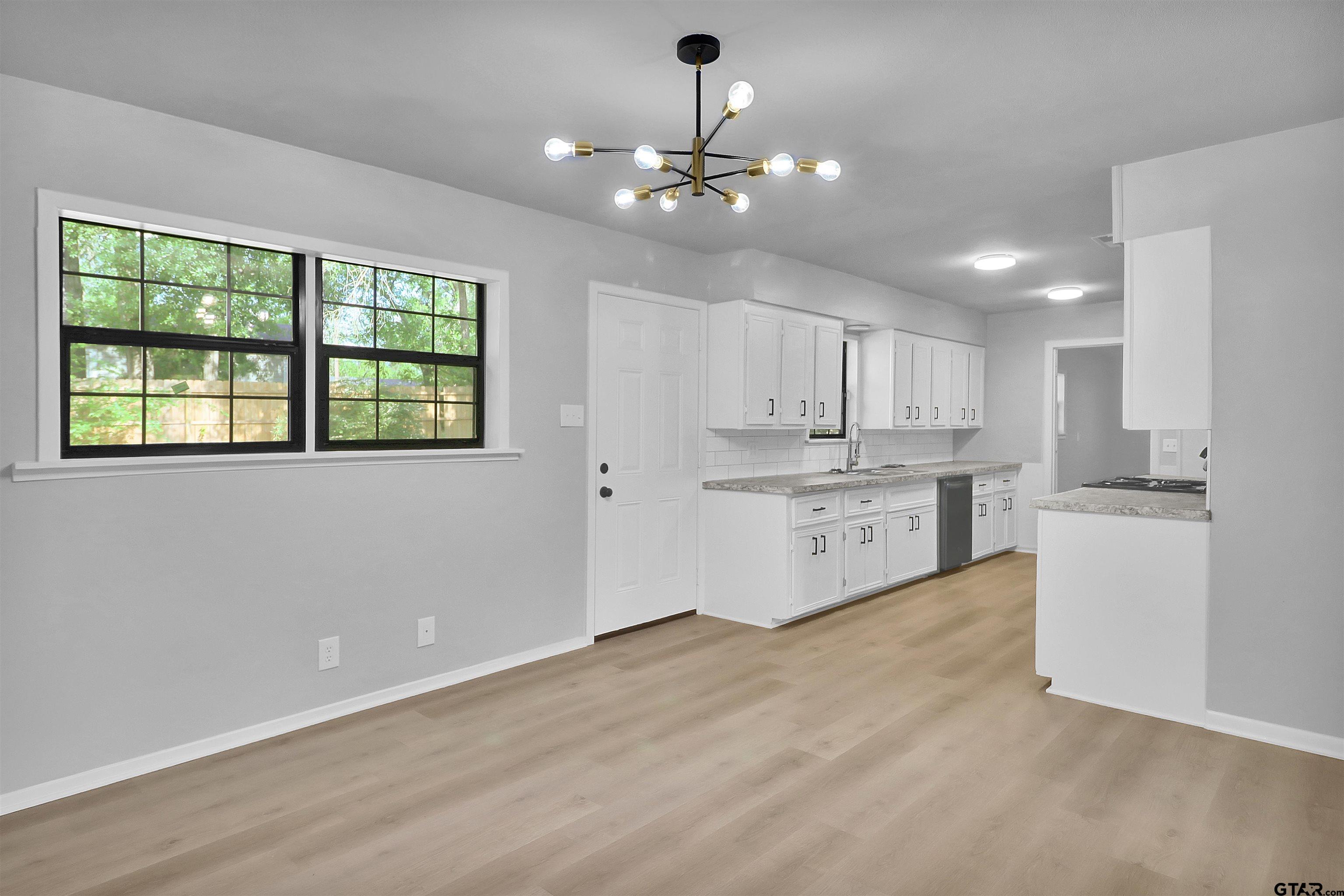 1310 Ridgeview Drive Tyler, TX 75701 - Photo 10 of 30 a view of a kitchen with a sink cabinets and outdoor space