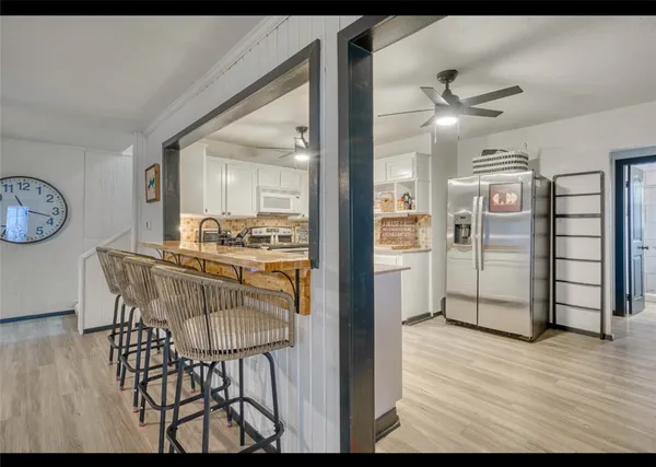 a kitchen with sink refrigerator and window