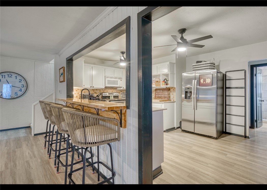 10967 Clyde Acord Road Franklin, TX 77856 - Photo 16 of 50 Kitchen featuring light hardwood / wood-style floors, white cabinetry, wooden counters, and appliances with stainless steel finishes