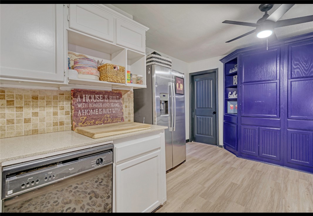 10967 Clyde Acord Road Franklin, TX 77856 - Photo 19 of 50 Kitchen with white cabinetry, ceiling fan, black dishwasher, stainless steel fridge with ice dispenser, and light hardwood / wood-style flooring