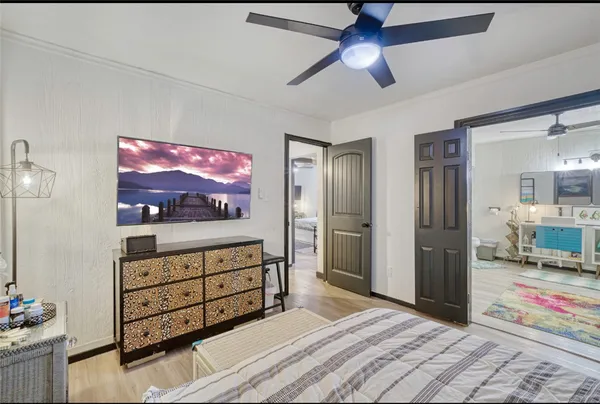 a bedroom with a bed and wooden floor