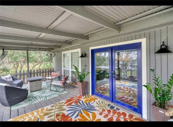 a view of a patio with couches table and chairs and potted plants