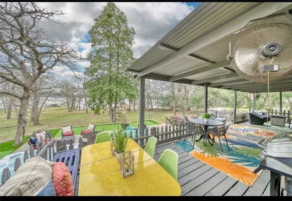 a view of a patio with table and chairs under an umbrella