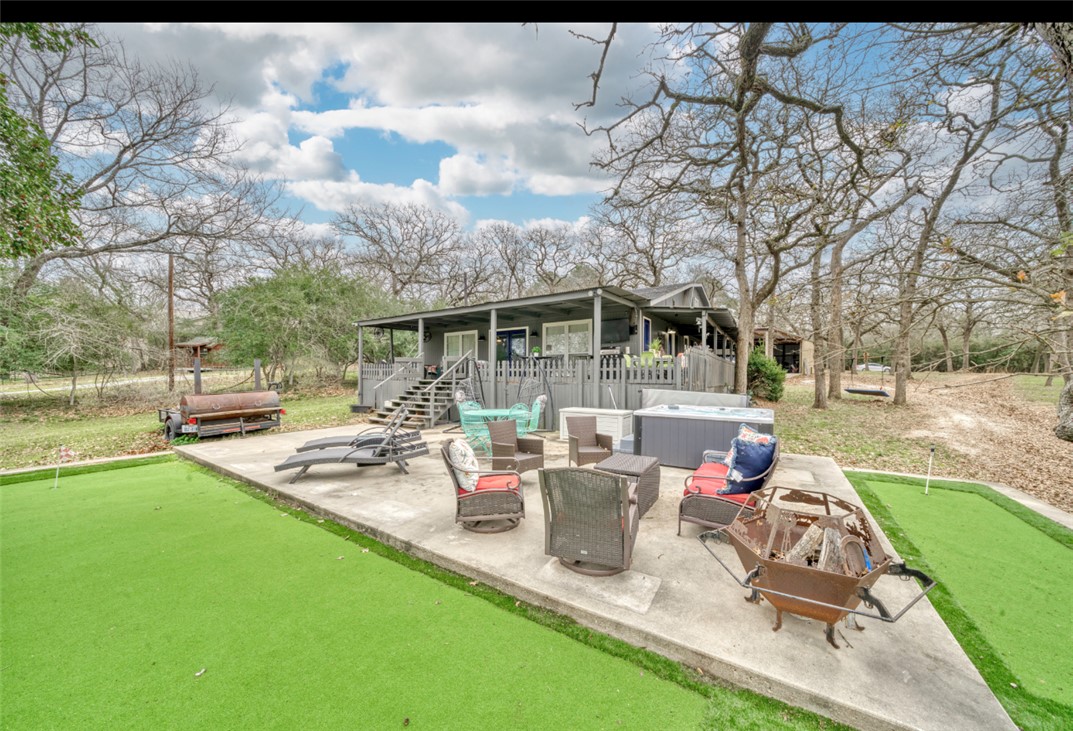 10967 Clyde Acord Road Franklin, TX 77856 - Photo 34 of 50 View of patio / terrace featuring an outdoor / hangout area and a hot tub/ putting green