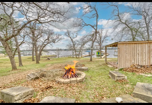 a big yard with trees in front of it