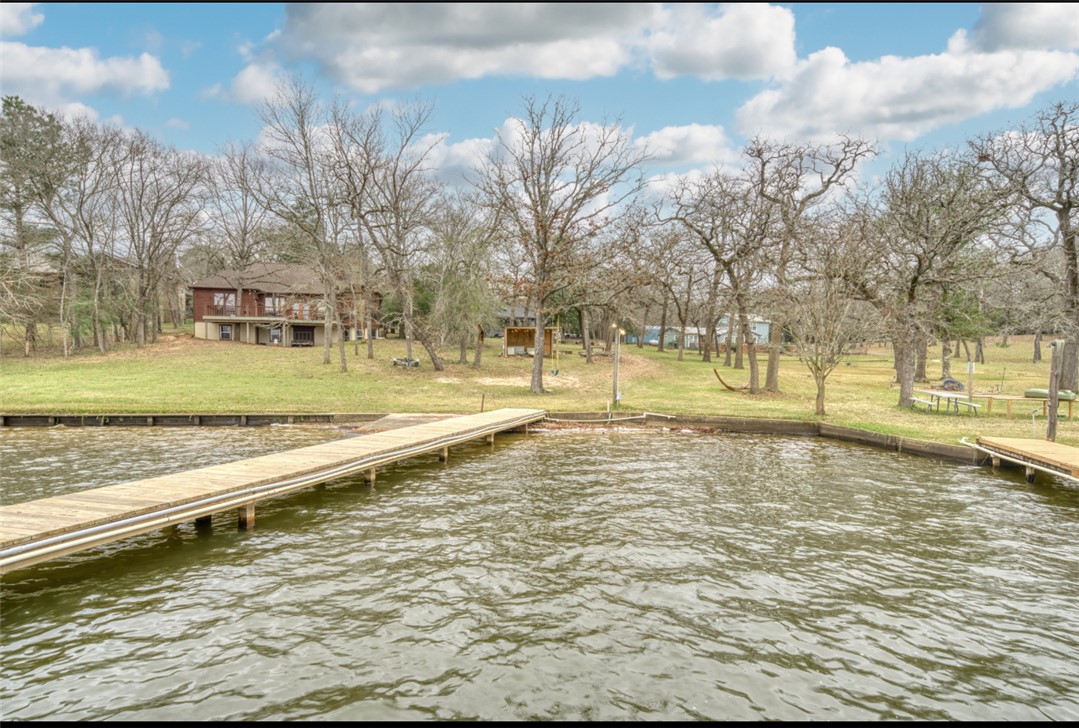 10967 Clyde Acord Road Franklin, TX 77856 - Photo 45 of 50 View of dock featuring a yard and a water view