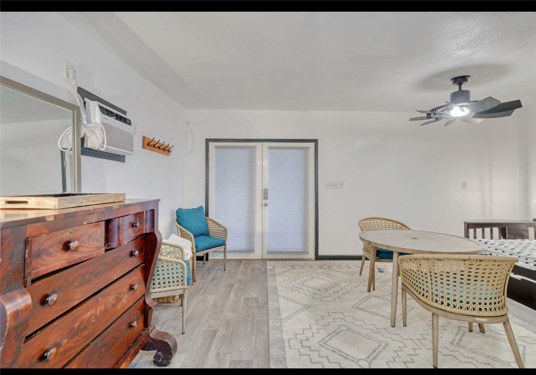 10967 Clyde Acord Road Franklin, TX 77856 - Photo 6 of 50 Dining room with ceiling fan, a wall mounted AC, and light hardwood / wood-style flooring