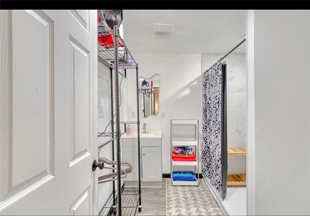 10967 Clyde Acord Road Franklin, TX 77856 - Photo 7 of 50 Bathroom with hardwood / wood-style floors, vanity, and walk in shower