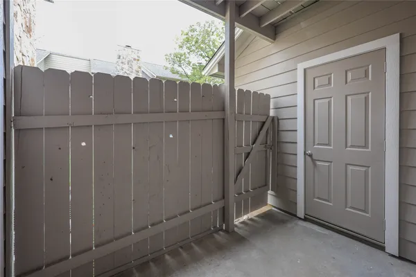 a view of a house with a wooden fence