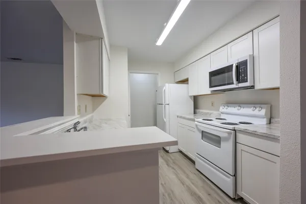 a kitchen with a sink a stove and refrigerator