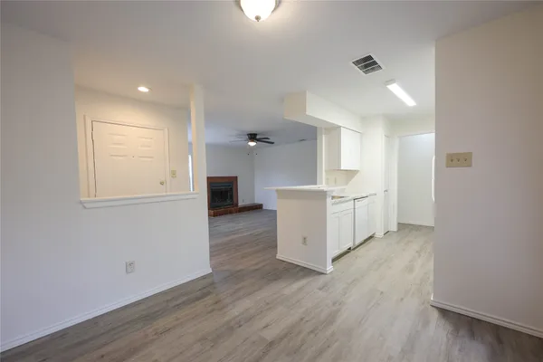 a view of a kitchen with wooden floor