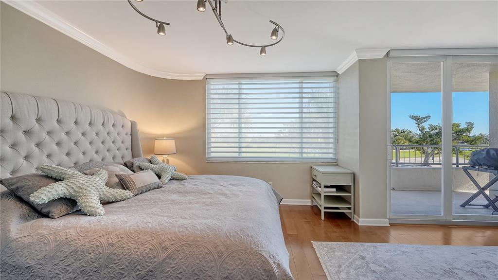 775 Longboat Club Road, Unit 204 Longboat Key, FL 34228 - Photo 24 of 40 a bedroom with furniture and a large window