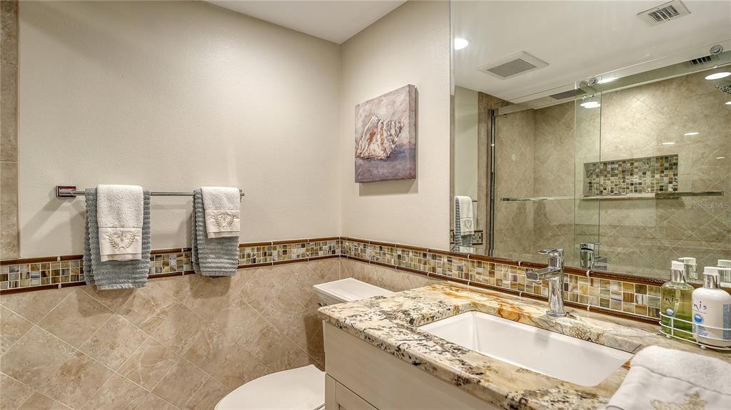 775 Longboat Club Road, Unit 204 Longboat Key, FL 34228 - Photo 27 of 40 a bathroom with a granite countertop sink and a mirror