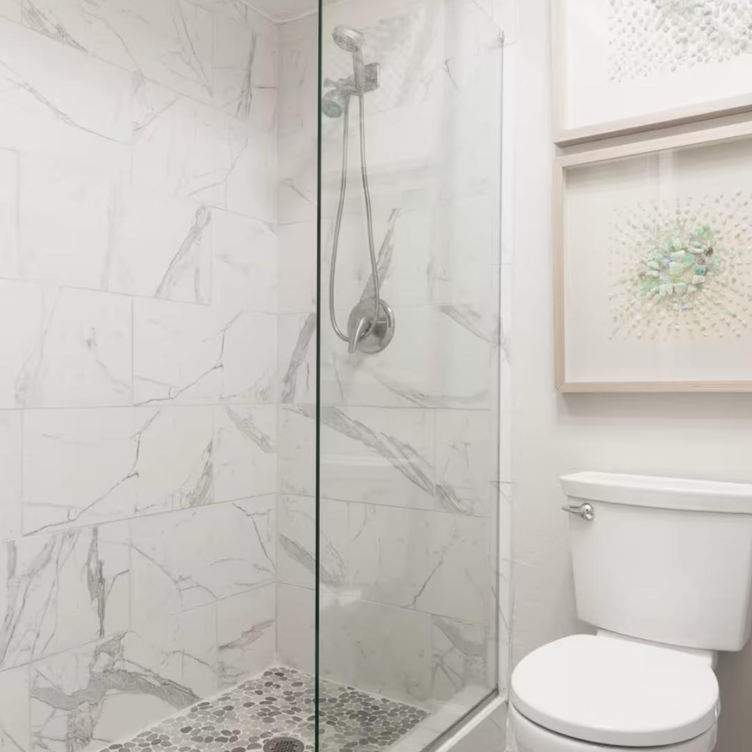 240 Rio Del Mar Boulevard, Unit O Aptos, CA 95003 - Photo 12 of 25 a white toilet next to a bathroom shower