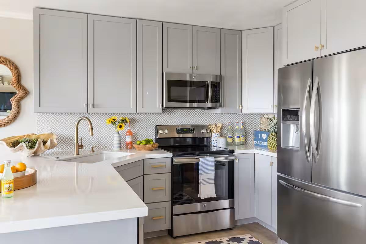 240 Rio Del Mar Boulevard, Unit O Aptos, CA 95003 - Photo 6 of 25 a kitchen with stainless steel appliances a stove a sink a refrigerator and cabinets
