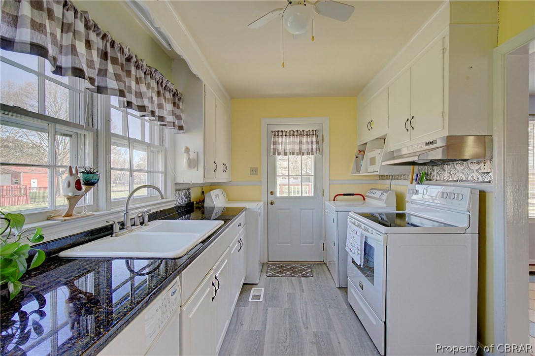 12 Old Meribeth Road Hampton, VA 23669 - Photo 14 of 32 Kitchen with a wealth of natural light, white cabinetry, light wood-type flooring, and washer and dryer