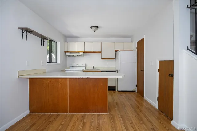 a hallway with a sink and dishwasher