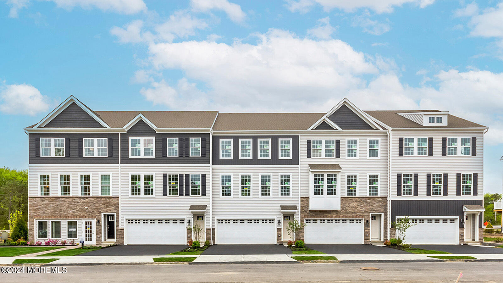 10 Rothbury Court Tinton Falls, NJ 07753 - Photo 1 of 43 a front view of a building with lot of cars and trees