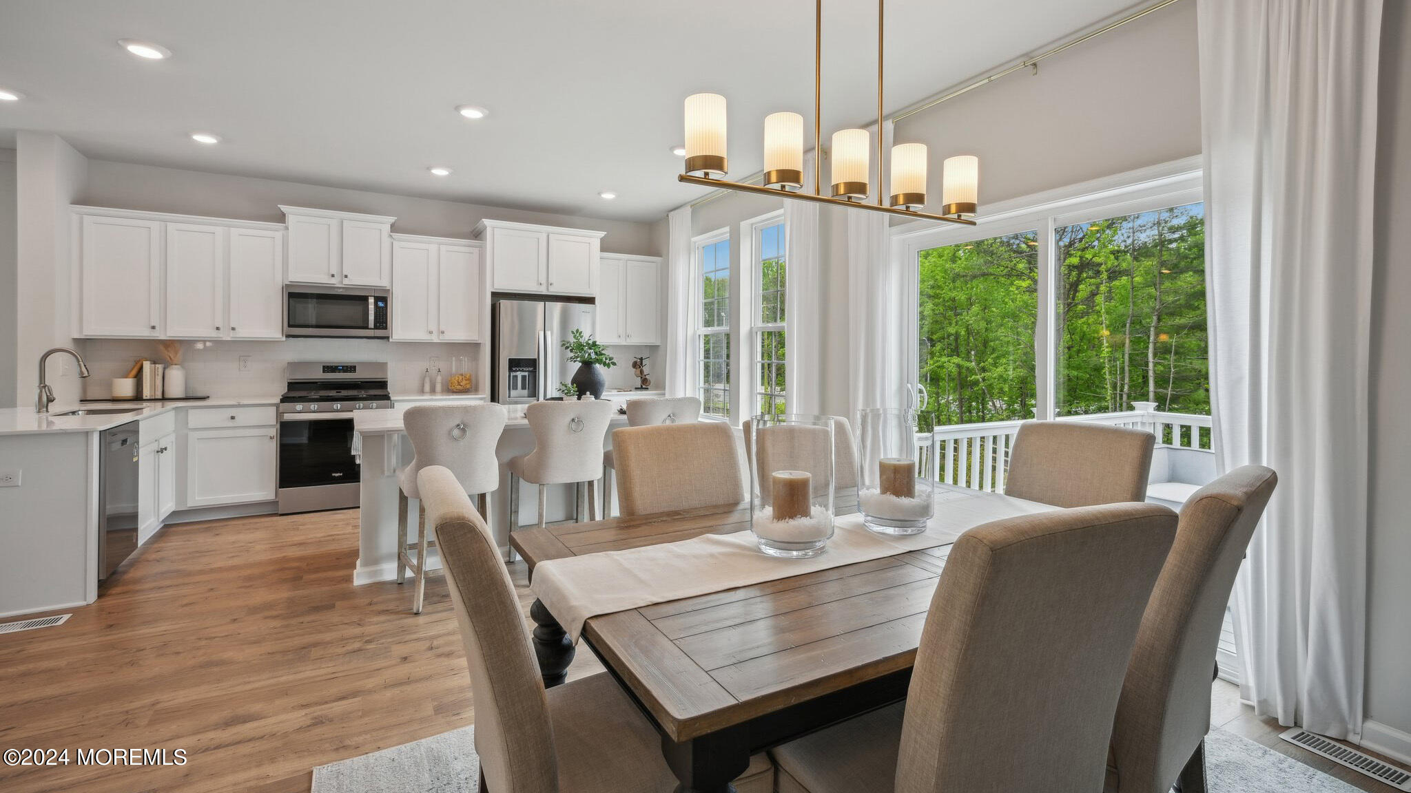 10 Rothbury Court Tinton Falls, NJ 07753 - Photo 15 of 43 a view of a dining room and a kitchen with a table chairs