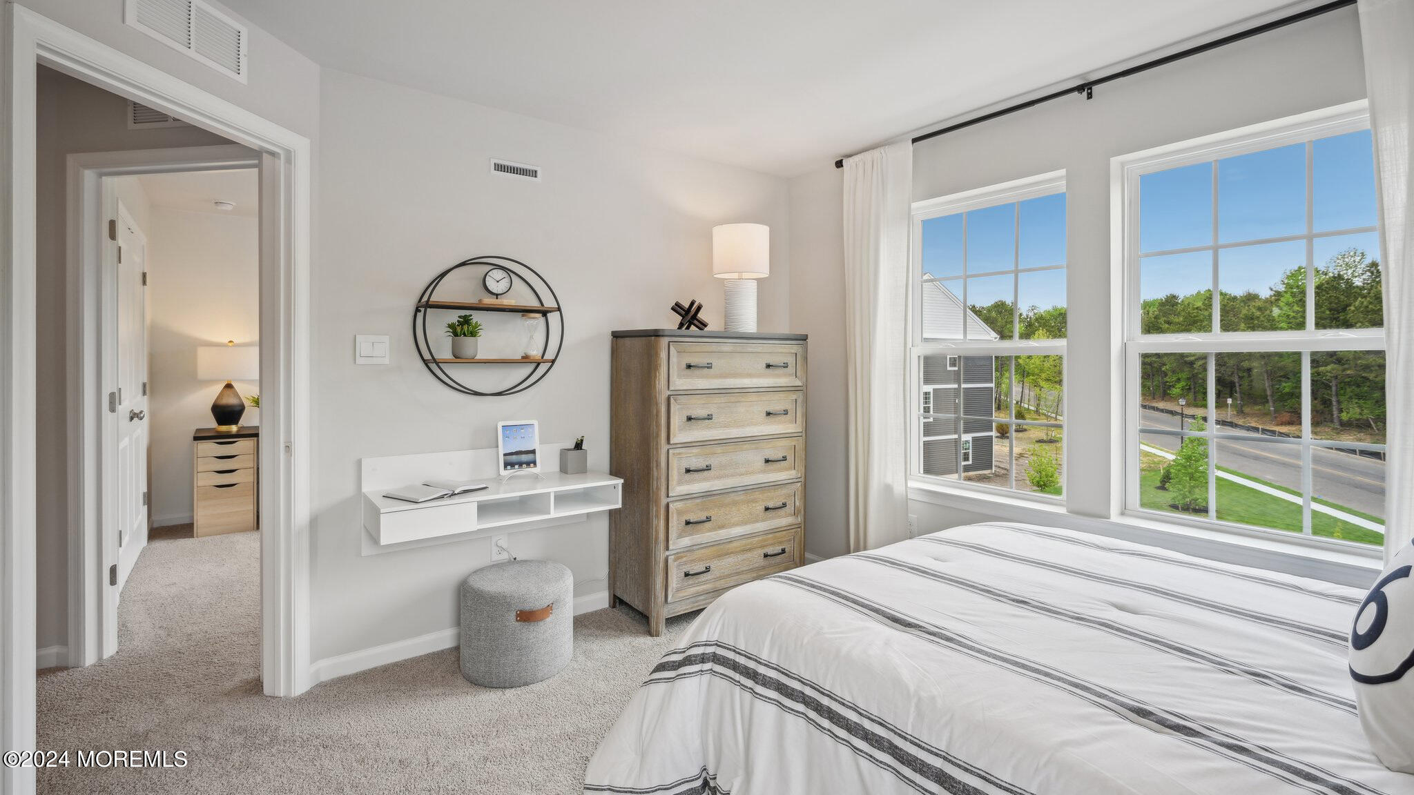 10 Rothbury Court Tinton Falls, NJ 07753 - Photo 27 of 43 a bedroom with a bed a chandelier and a large window
