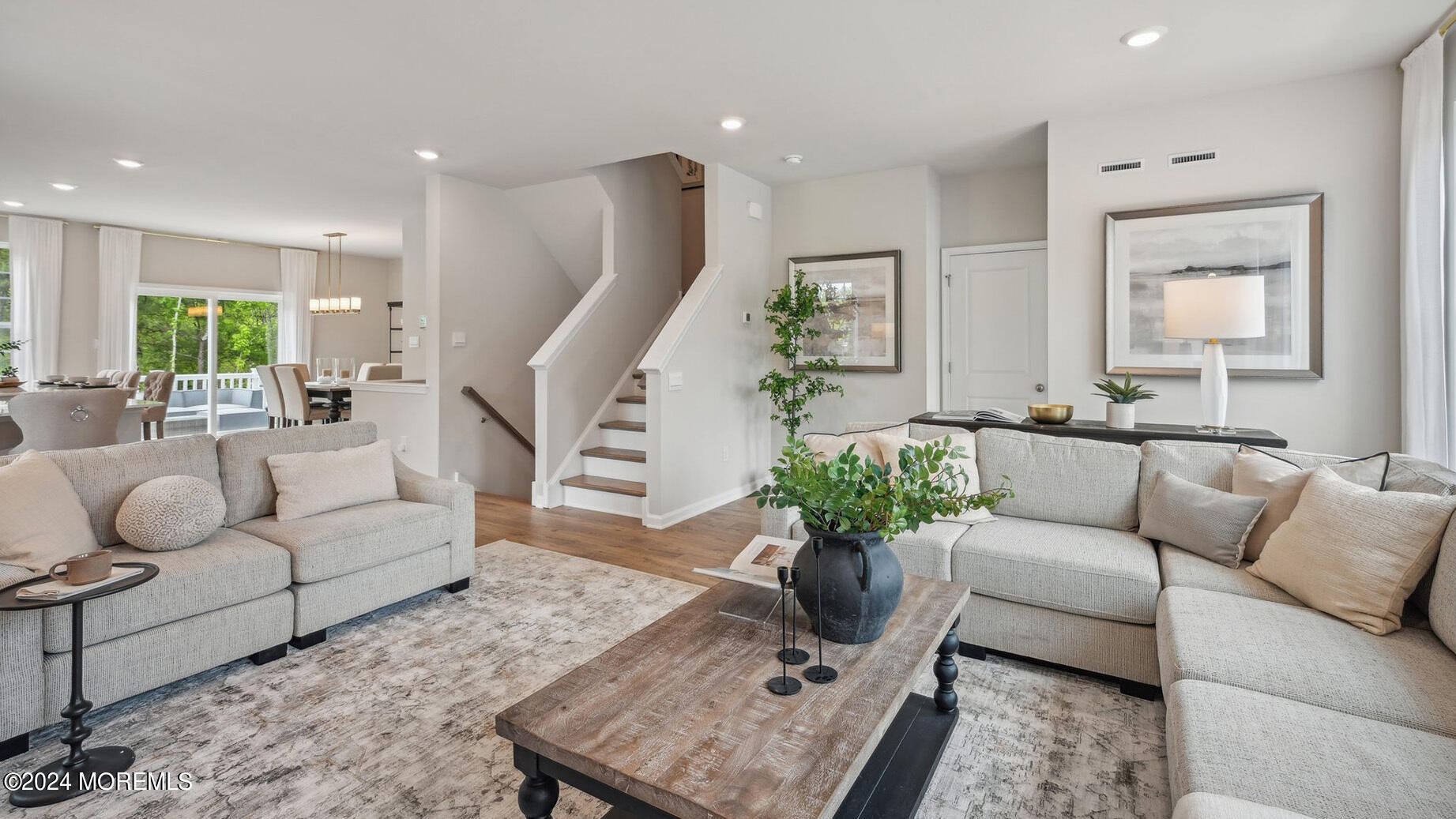 10 Rothbury Court Tinton Falls, NJ 07753 - Photo 10 of 43 a living room with furniture potted plant and a wooden floor