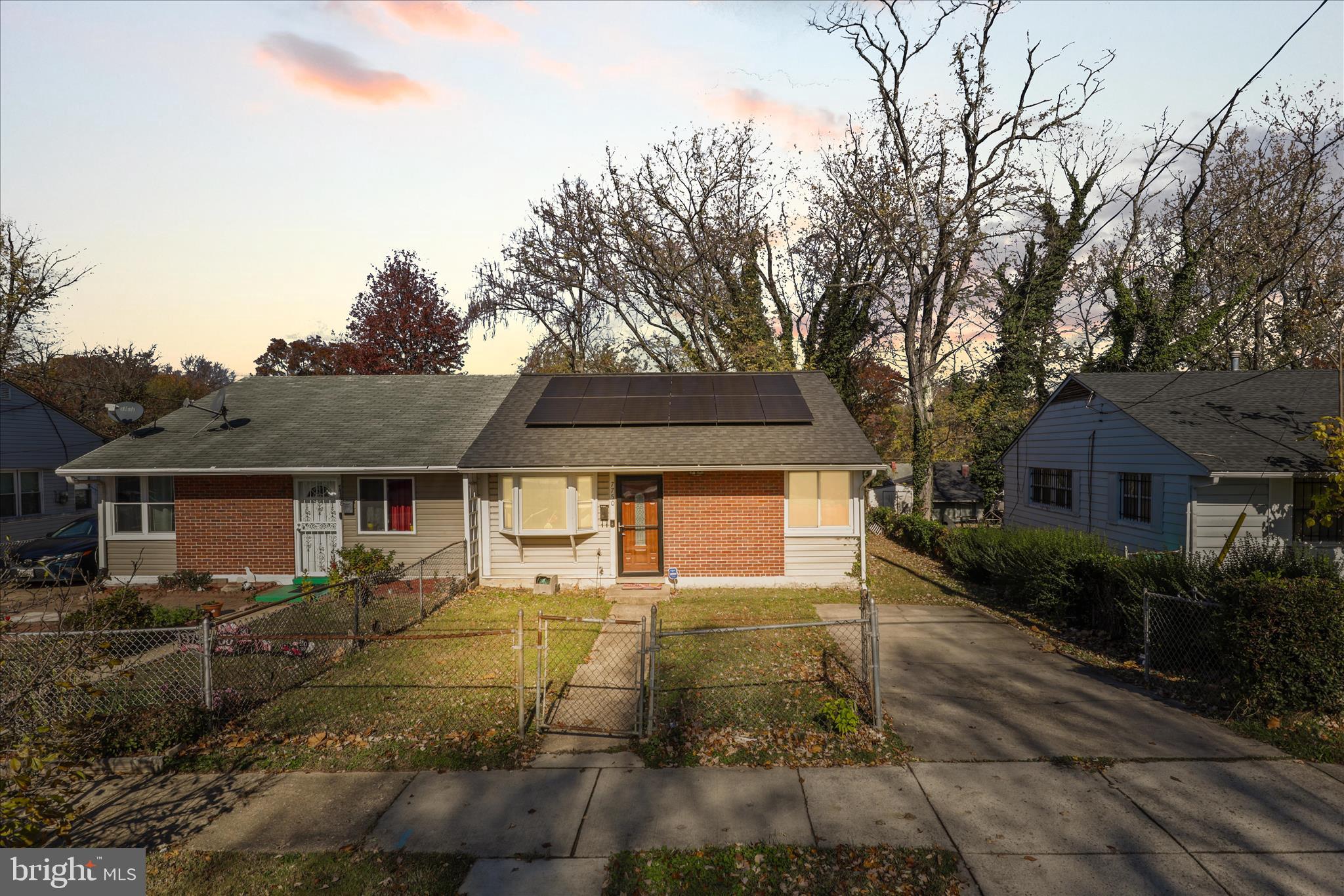 a front view of house with yard and trees around
