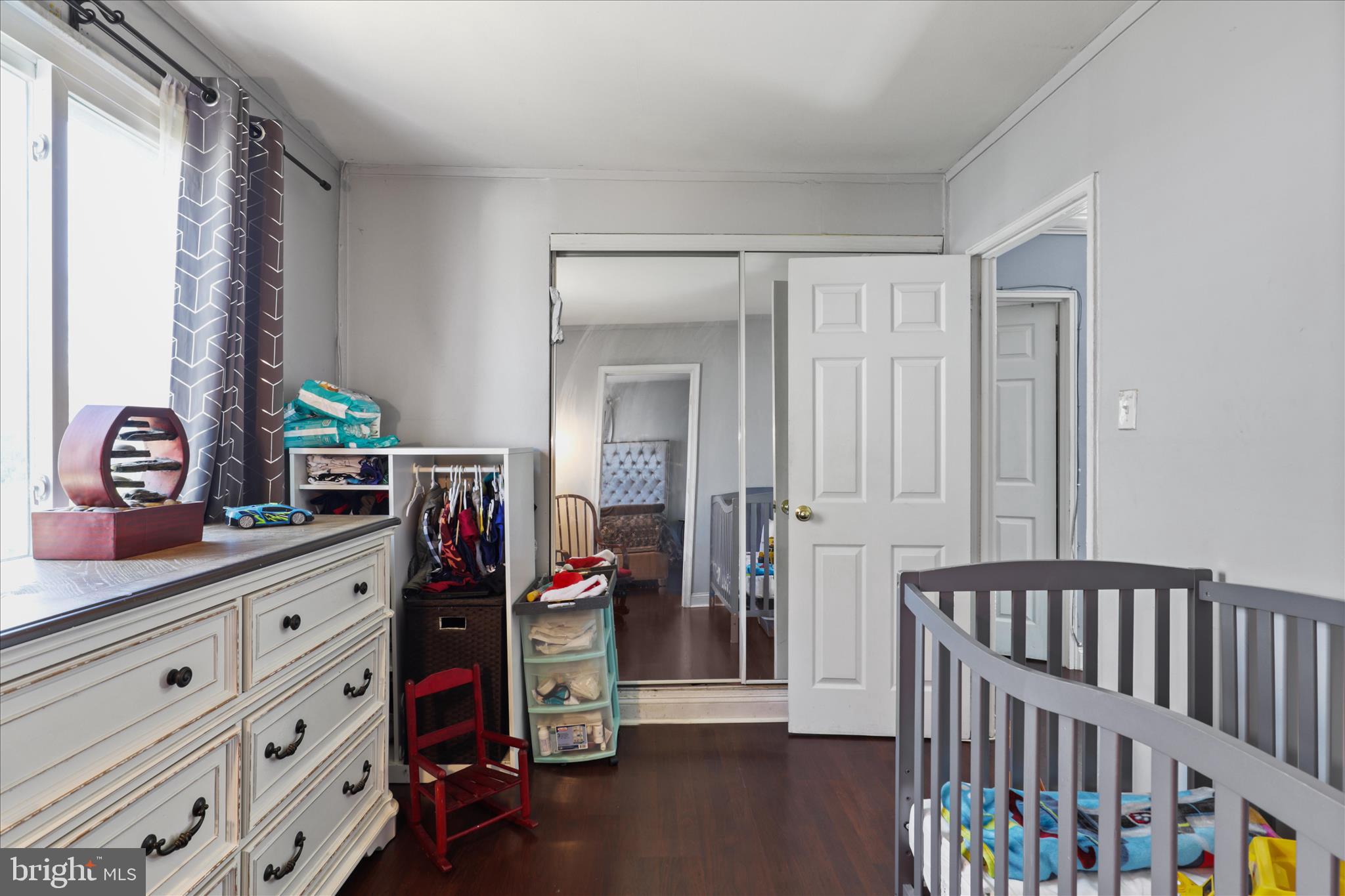 7750 Normandy Road Landover, MD 20785 - Photo 16 of 27 a bedroom with a bed and wooden floor