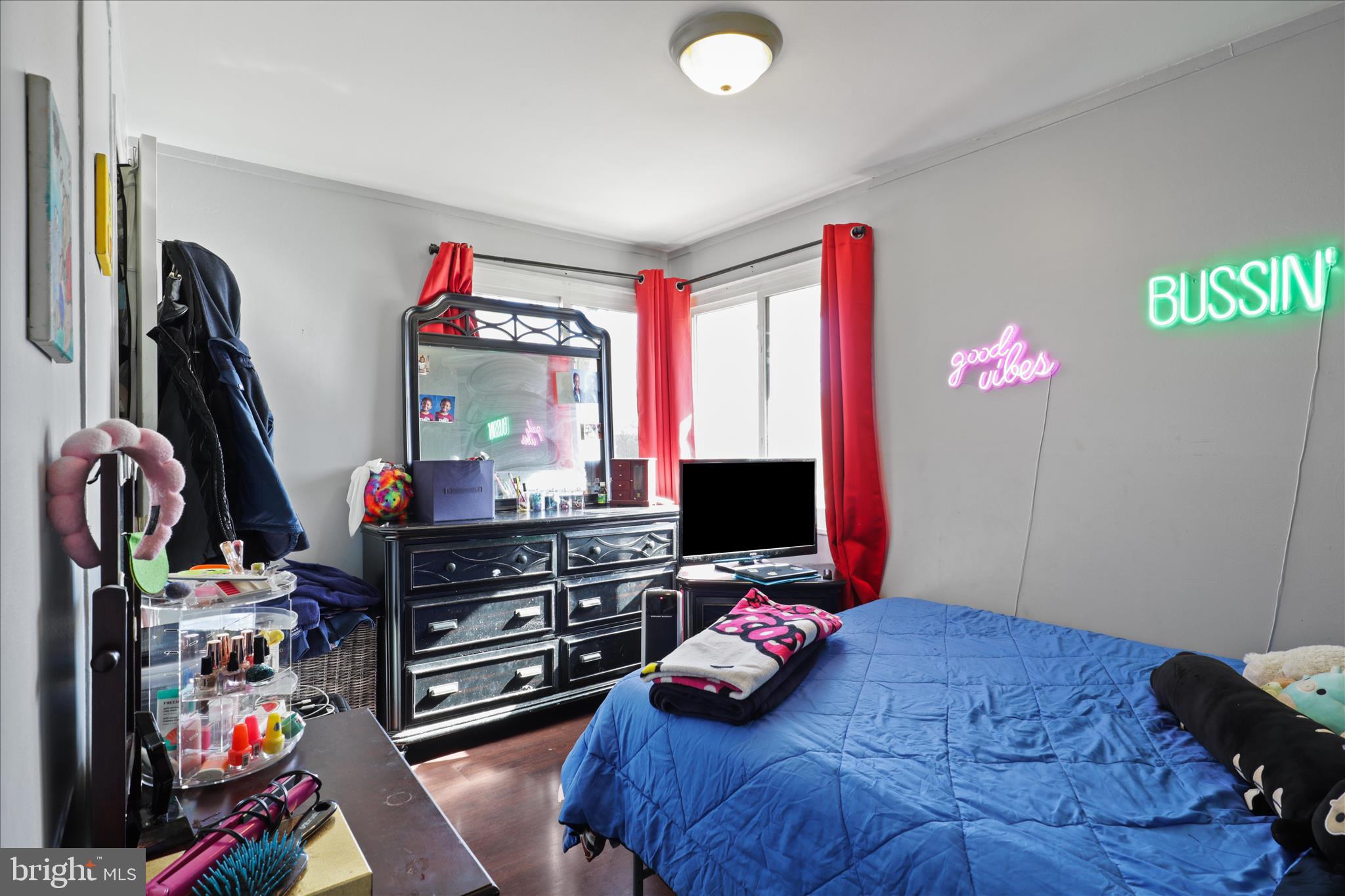 7750 Normandy Road Landover, MD 20785 - Photo 17 of 27 a bedroom with a bed desk and a flat tv screen