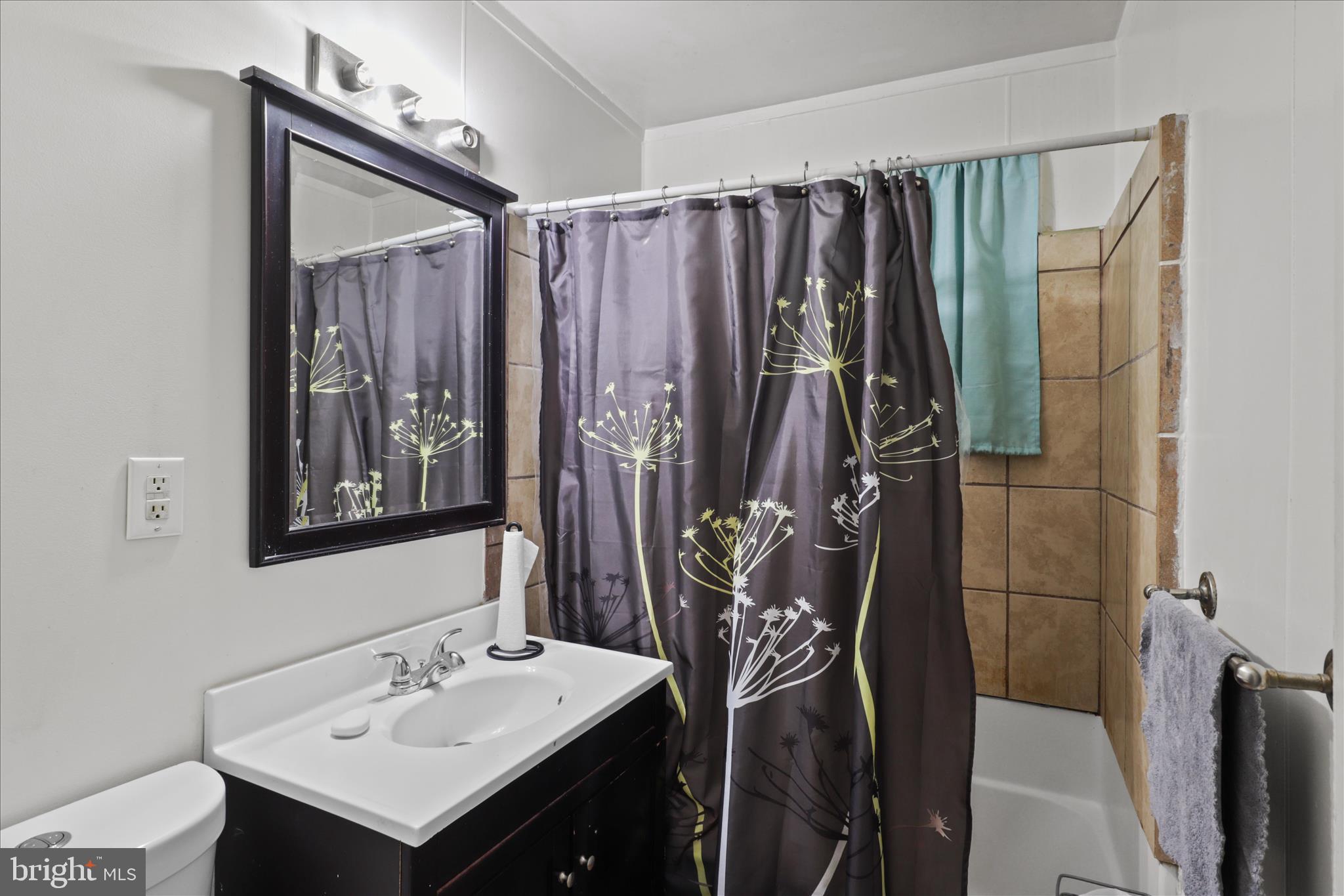 7750 Normandy Road Landover, MD 20785 - Photo 18 of 27 a bathroom with a sink vanity and a mirror