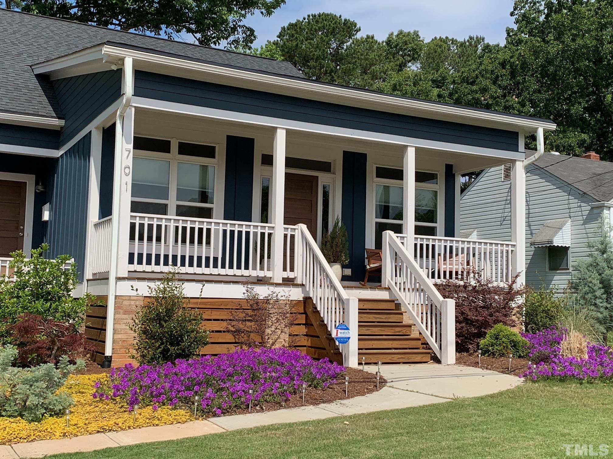 a view of a house with wooden deck and a yard