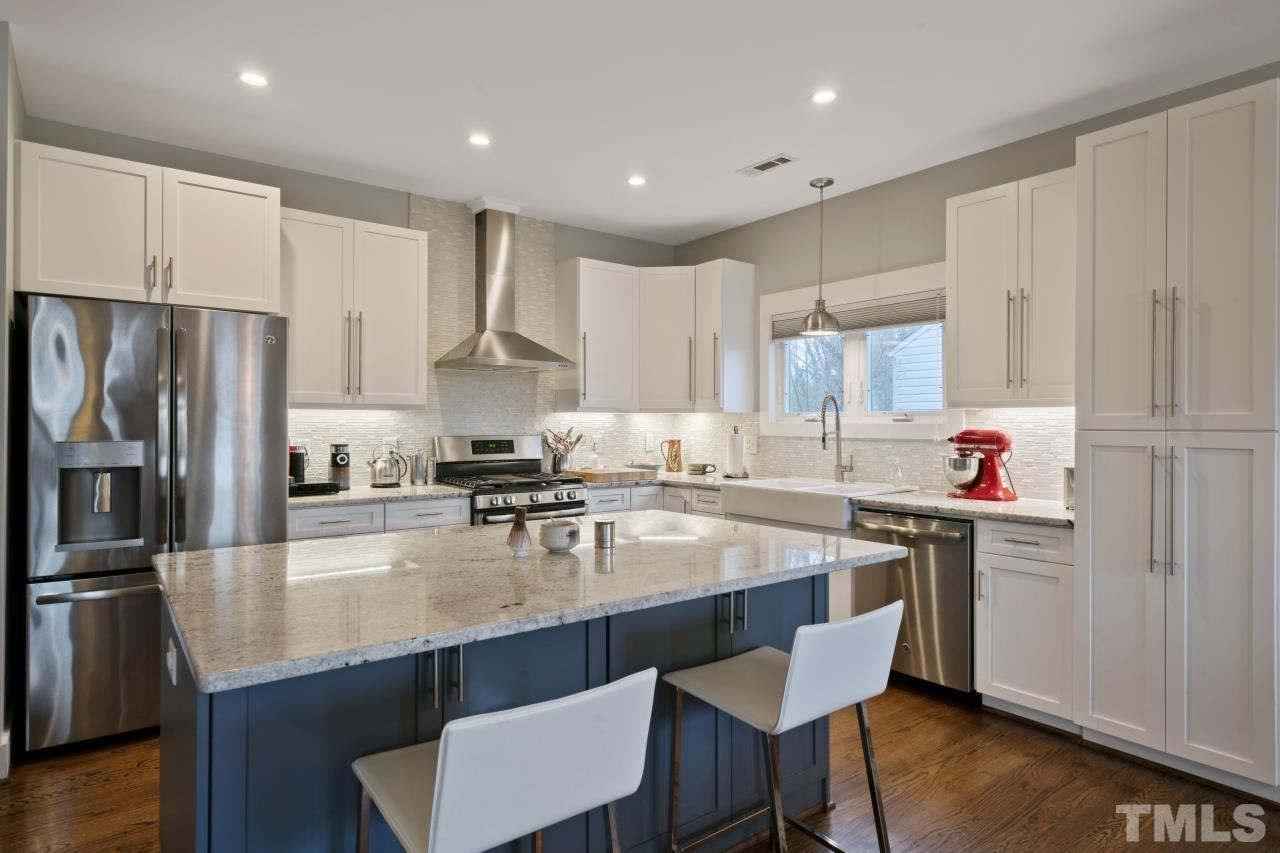701 Colleton Road Raleigh, NC 27610 - Photo 11 of 39 a kitchen with white cabinets stove and refrigerator