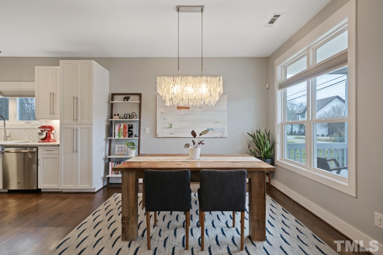 701 Colleton Road Raleigh, NC 27610 - Photo 12 of 39 a dining room with furniture a chandelier and wooden floor