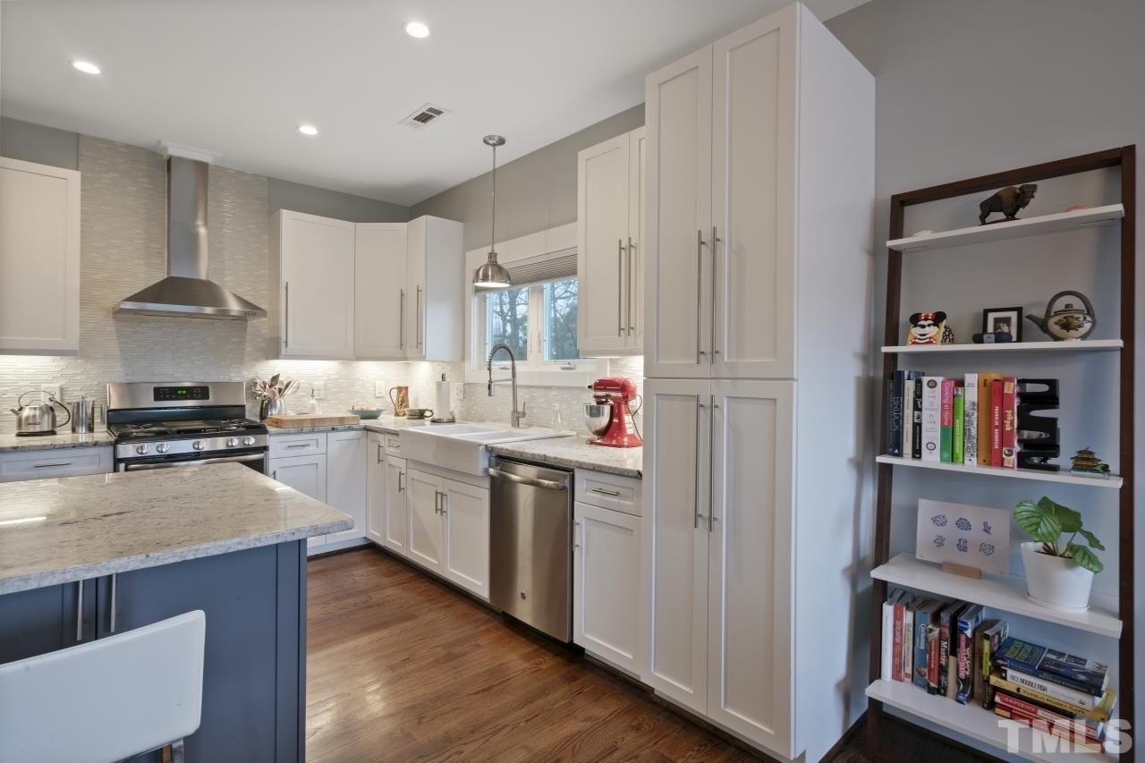 701 Colleton Road Raleigh, NC 27610 - Photo 13 of 39 a kitchen with cabinets and wooden floor