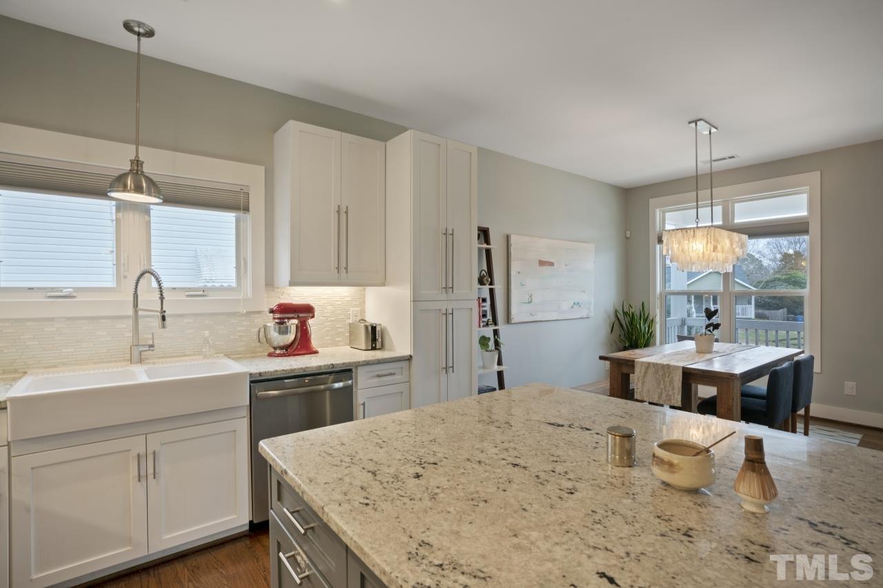 701 Colleton Road Raleigh, NC 27610 - Photo 17 of 39 a kitchen with stainless steel appliances a sink stove and refrigerator