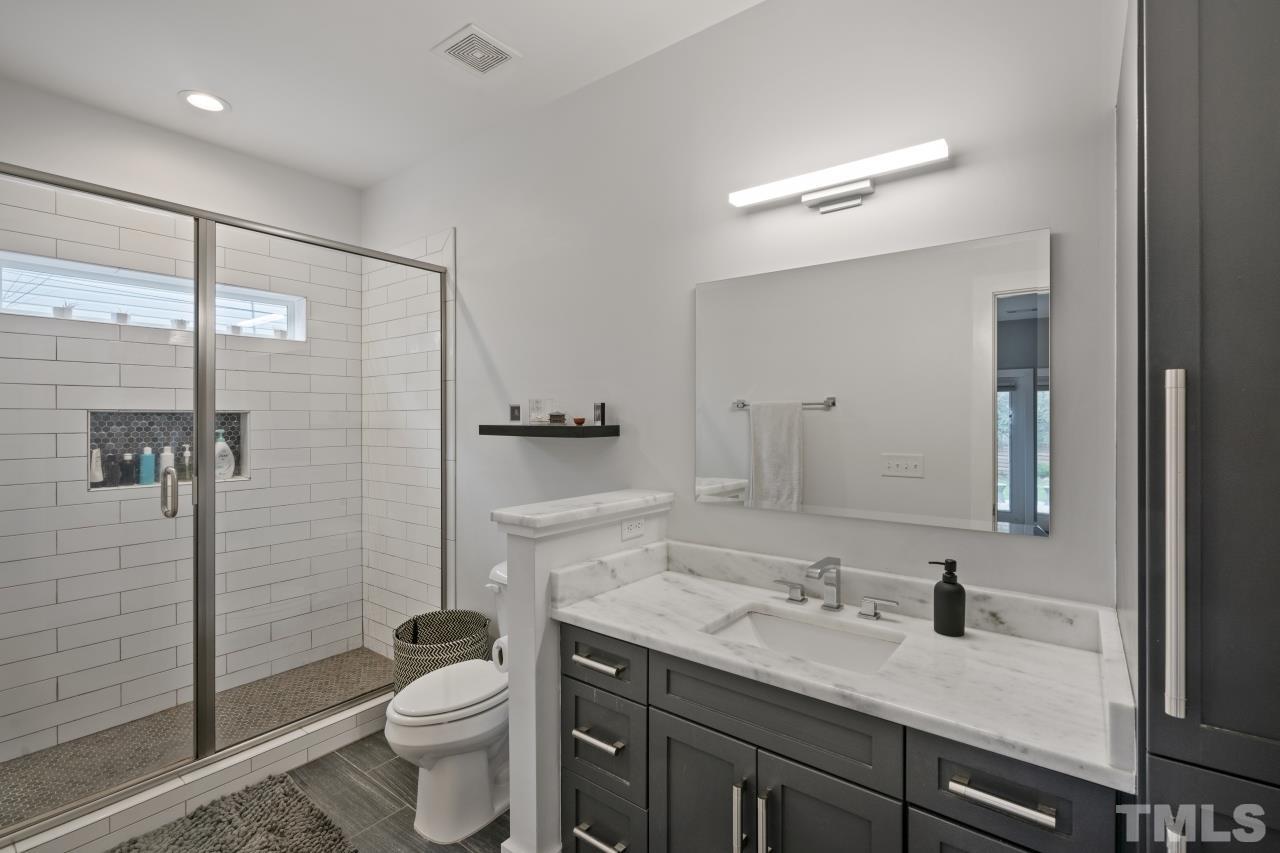 701 Colleton Road Raleigh, NC 27610 - Photo 22 of 39 a bathroom with a granite countertop sink toilet and shower