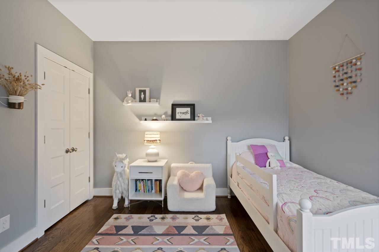 701 Colleton Road Raleigh, NC 27610 - Photo 25 of 39 a bedroom with a bed and wooden floor