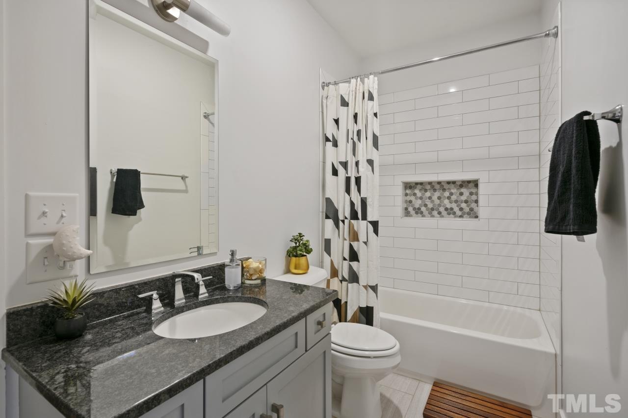 701 Colleton Road Raleigh, NC 27610 - Photo 26 of 39 a bathroom with a granite countertop sink toilet and shower