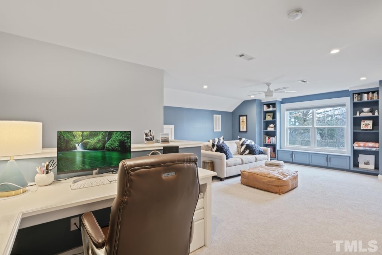 701 Colleton Road Raleigh, NC 27610 - Photo 29 of 39 a living room with fireplace furniture and a large window
