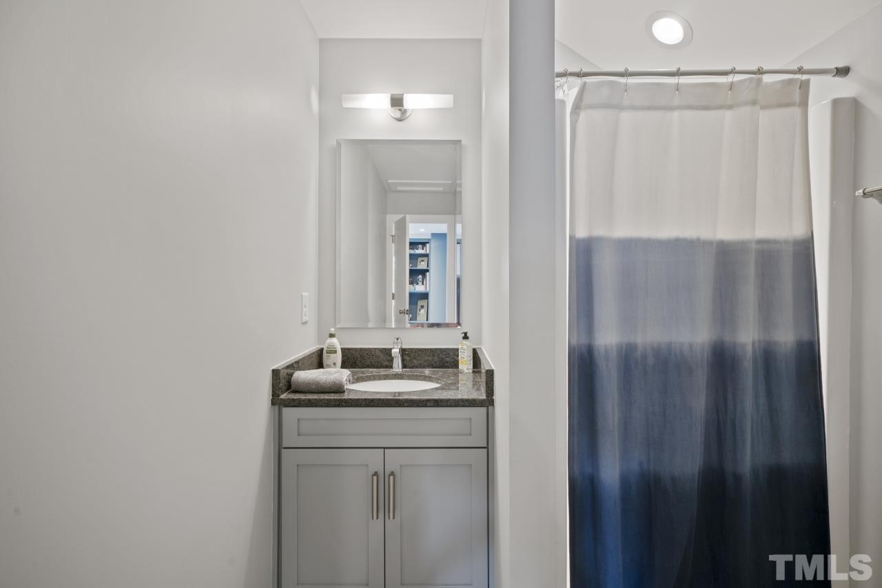701 Colleton Road Raleigh, NC 27610 - Photo 32 of 39 a bathroom with a double vanity sink and mirror