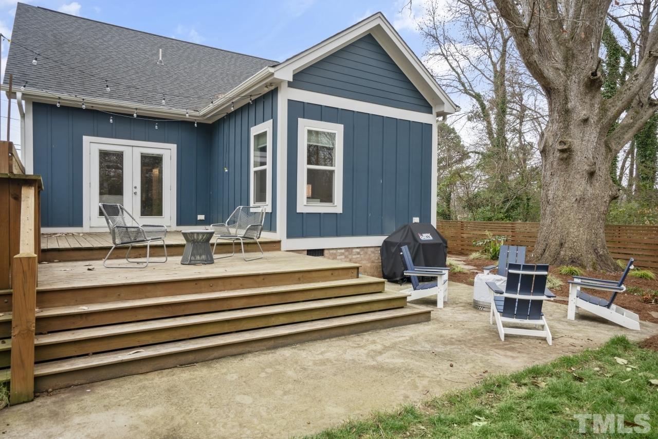 701 Colleton Road Raleigh, NC 27610 - Photo 34 of 39 a front view of a house with glass windows and table chairs