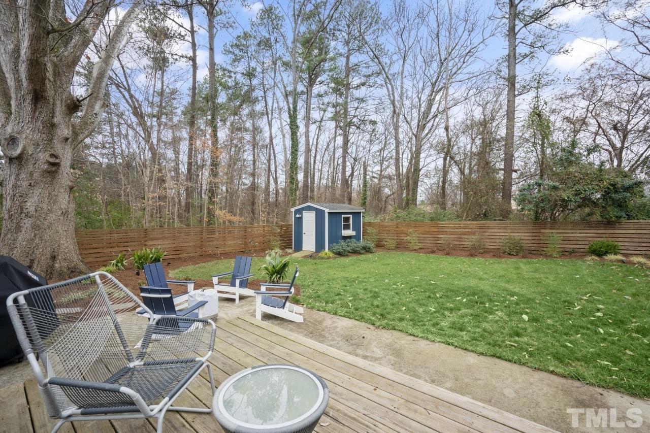 701 Colleton Road Raleigh, NC 27610 - Photo 37 of 39 a view of a backyard with table and chairs potted plants and tree