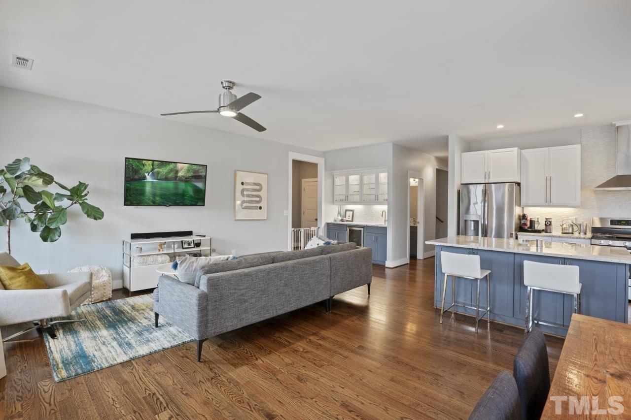 701 Colleton Road Raleigh, NC 27610 - Photo 5 of 39 a living room with furniture wooden floor and a flat screen tv