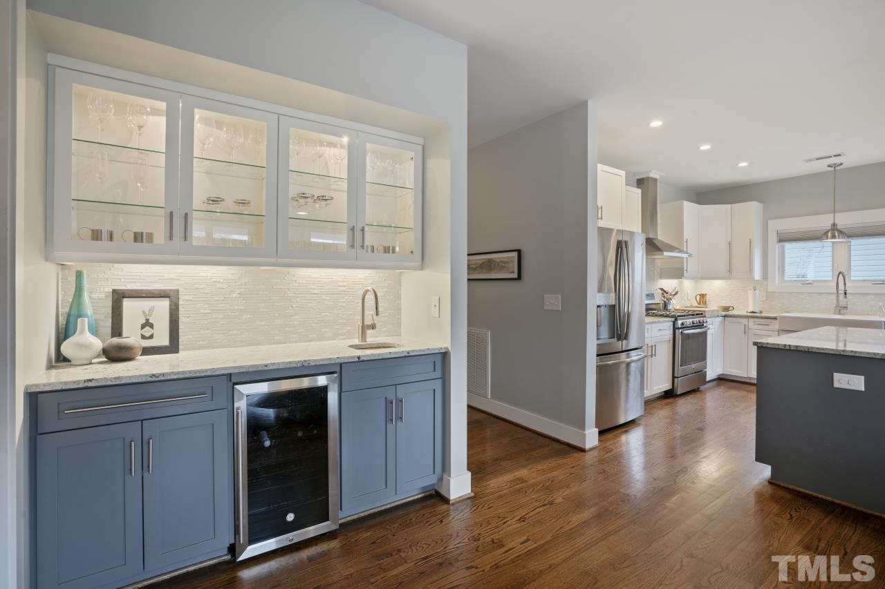 701 Colleton Road Raleigh, NC 27610 - Photo 9 of 39 a kitchen with stainless steel appliances granite countertop a refrigerator a sink dishwasher a stove and white countertops with wooden floor