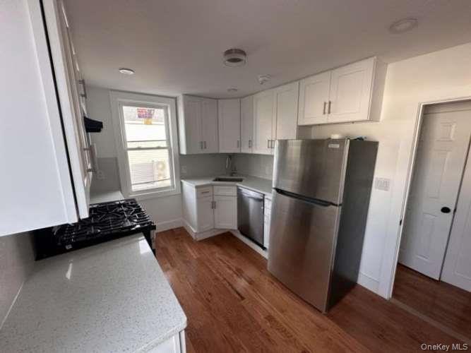 4401 Clarendon Road, Unit 1 Brooklyn, NY 11203 - Photo 3 of 6 a kitchen with a refrigerator a stove a sink and a window