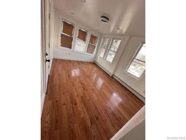 a view of an entryway with wooden floor