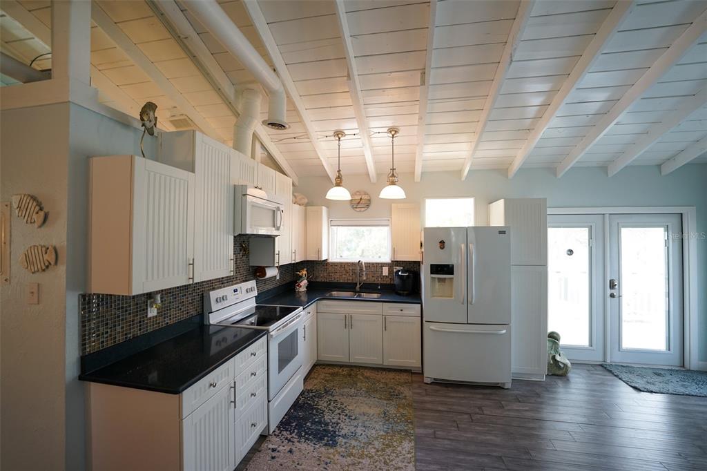 3480 Harbor Drive Weeki Wachee, FL 34607 - Photo 11 of 31 a kitchen with granite countertop a refrigerator and a sink